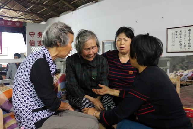 Victims comfort each other at a temporary shelter after a landslide hit the village of Sucun in Suichang county, east China's Zhejiang province on September 29. (AFP) Victims comfort each other at a temporary shelter after a landslide hit the village of Sucun in Suichang county, east China's Zhejiang province on September 29. (AFP)