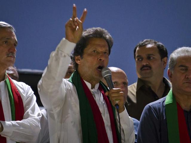 Imran Khan, the head of Pakistan Tehreek-e-Insaf, addresses his supporters during a rally.(AP Photo)