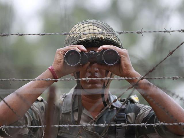 A Border Security Force soldier looks across the Pakistan side of the border through a binocular at Ranbir Singh Pura, about 35 kilometers from Jammu, on September 24, 2016. (AP) A Border Security Force soldier looks across the Pakistan side of the border through a binocular at Ranbir Singh Pura, about 35 kilometers from Jammu, on September 24, 2016. (AP)