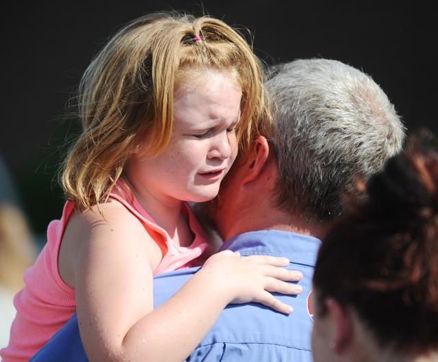 Lilly Chapman, 8, cries after being reunited with her father at Oakdale Baptist Church on Wednesday. (AP) Lilly Chapman, 8, cries after being reunited with her father at Oakdale Baptist Church on Wednesday. (AP)