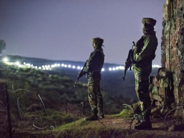 In this file photo, Indian Army soldiers can be seen at a post before the illuminated fence in Hamirpur area near Bhimber Gali, about 180km northwest of Jammu.(Gurinder Osan/HT File Photo)