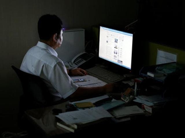A North Korean defector, who declined to be named and requested his face not to be photographed due to his safety, looks at a screen as he poses for photographs after an interview with Reuters in Seoul, South Korea, on Thursday.(REUTERS)