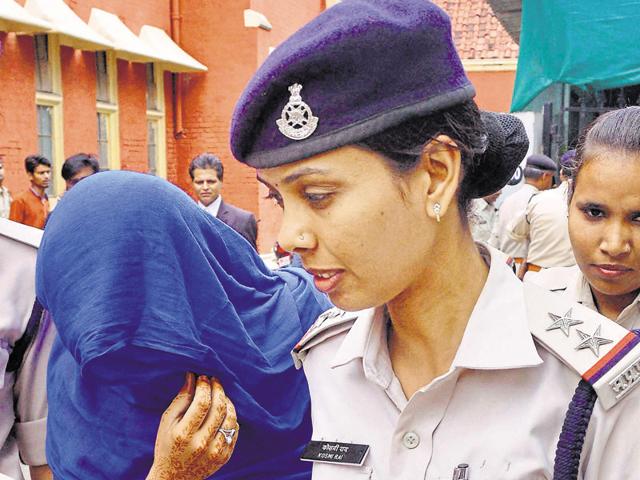 Ritu Ahuja is taken away after a court sentenced her with life term for killing her daughter, in Jabalpur on Wednesday. (PTI)