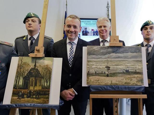 Director of Amsterdam's Van Gogh Museum Alex Rueger, center, stands next to the paintings Congregation Leaving The Reformed Church of Nuenen, left, and 1882 Seascape at Scheveningen by Vincent Van Gogh, during a press conference in Naples, Italy, Friday, Sept. 30, 2016. (AP) Director of Amsterdam's Van Gogh Museum Alex Rueger, center, stands next to the paintings Congregation Leaving The Reformed Church of Nuenen, left, and 1882 Seascape at Scheveningen by Vincent Van Gogh, during a press conference in Naples, Italy, Friday, Sept. 30, 2016. (AP)