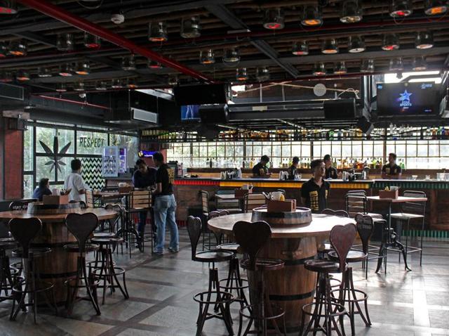 On the fourth floor, the elevator opens directly into a large room with an expansive, prominent bar at one end and seating occupying the rest of the space.(Satyabrata Tripathy/ HT Photo)