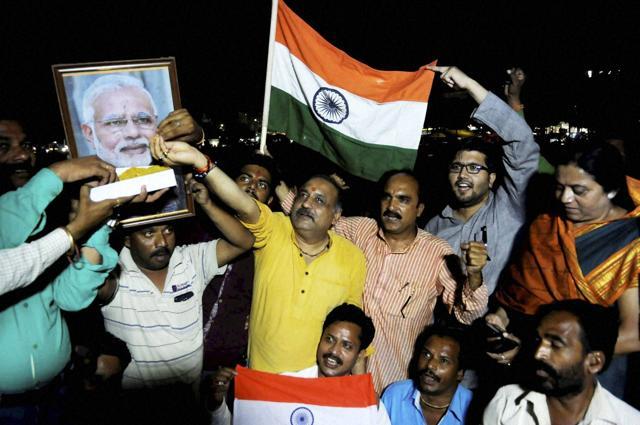 Bharatiya Janata Party ( BJP ) workers offering sweets to a poster of Prime Minister Narendra Modi to celebrate the surgical strikes across the LoC, in Bhopal on Thursday. (PTI) Bharatiya Janata Party ( BJP ) workers offering sweets to a poster of Prime Minister Narendra Modi to celebrate the surgical strikes across the LoC, in Bhopal on Thursday. (PTI)
