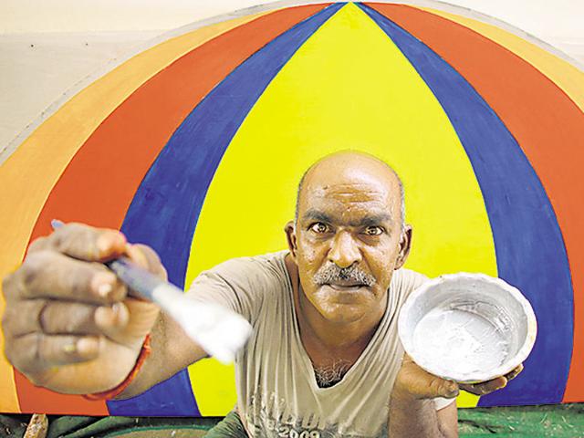 A worker gives final touches to the Ramlila stage at Noida stadium.(Salman Ali/HT Photo) A worker gives final touches to the Ramlila stage at Noida stadium.(Salman Ali/HT Photo)