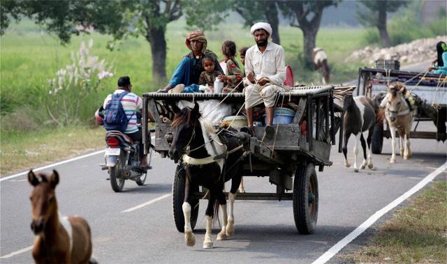 A man moves out of Paloora village about 55km from Jammu to safety with his family. (PTI) A man moves out of Paloora village about 55km from Jammu to safety with his family. (PTI)