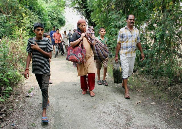 Villagers living close to the India- Pakistan border being shifted for safer places at Hamirpur village of Akhnoor sector about 60 km from Jammu. (PTI) Villagers living close to the India- Pakistan border being shifted for safer places at Hamirpur village of Akhnoor sector about 60 km from Jammu. (PTI)