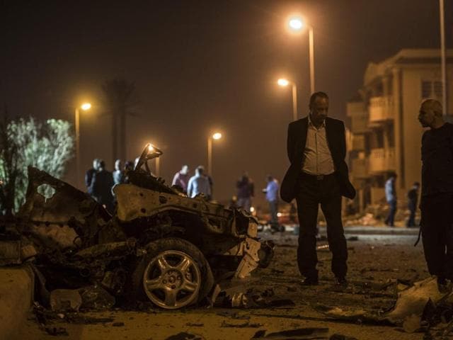 Egyptian official inspect the wreckages of a car bomb exploded in a Cairo suburb after Egypt's deputy prosecutor general drove late on Friday. (AFP) Egyptian official inspect the wreckages of a car bomb exploded in a Cairo suburb after Egypt's deputy prosecutor general drove late on Friday. (AFP)