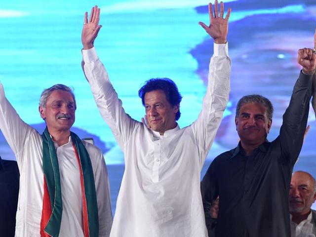 Pakistani cricketer-turned-politician Imran Khan waves to supporters during a public meeting in Raiwind, around 40km from Lahore.(AFP Photo)