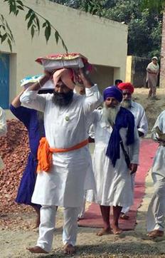 Guru Granth Sahib being shifted from Dauke village by SGPC members, near Amritsar. (HT Photo)