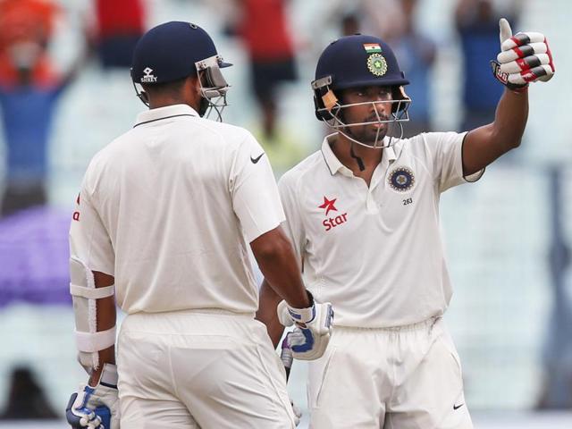 Wriddhiman Saha, right, gestures towards the dressing room after completing his half-century. (AP photo) Wriddhiman Saha, right, gestures towards the dressing room after completing his half-century. (AP photo)