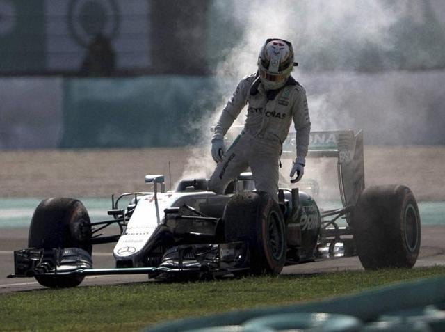 Mercedes driver Lewis Hamilton of Britain leaves his car after an engine failure during the Malaysian GP. (AP Photo) Mercedes driver Lewis Hamilton of Britain leaves his car after an engine failure during the Malaysian GP. (AP Photo)