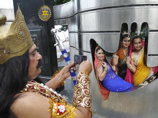 Ramlila artistes click photos at Sukhna Lake in Chandigarh on Saturday. (Karun Sharma/HT)