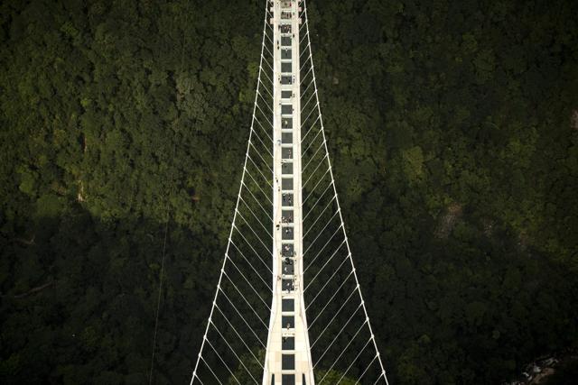 The world's highest and longest glass-bottomed bridge is seen above a valley in Zhangjiajie in China's Hunan Province. (AFP) The world's highest and longest glass-bottomed bridge is seen above a valley in Zhangjiajie in China's Hunan Province. (AFP)