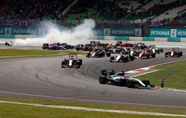 Mercedes' Lewis Hamilton of Britain leads as Mercedes' Nico Rosberg of Germany skids to the back during the first lap of the race. (REUTERS) Mercedes' Lewis Hamilton of Britain leads as Mercedes' Nico Rosberg of Germany skids to the back during the first lap of the race. (REUTERS)