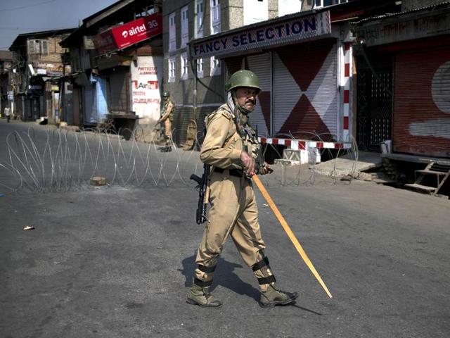 A paramilitary soldier stands guard during a curfew in Srinagar on September 30, 2016. (AP) A paramilitary soldier stands guard during a curfew in Srinagar on September 30, 2016. (AP)