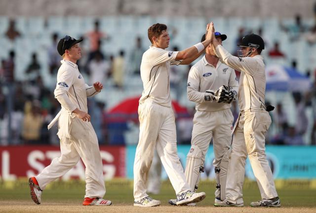 New Zealand's Mitchell Santner, second left, celebrates with team mates after taking the wicket of Indian cricketer Ravindra Jadeja. (AP Photo)