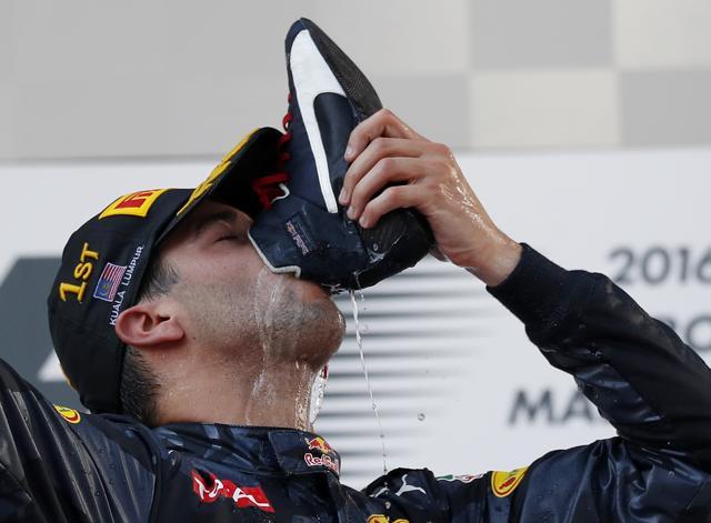 Ricciardo celebrates his first win of the season by drinking champagne out of his shoe. (AP) Ricciardo celebrates his first win of the season by drinking champagne out of his shoe. (AP)