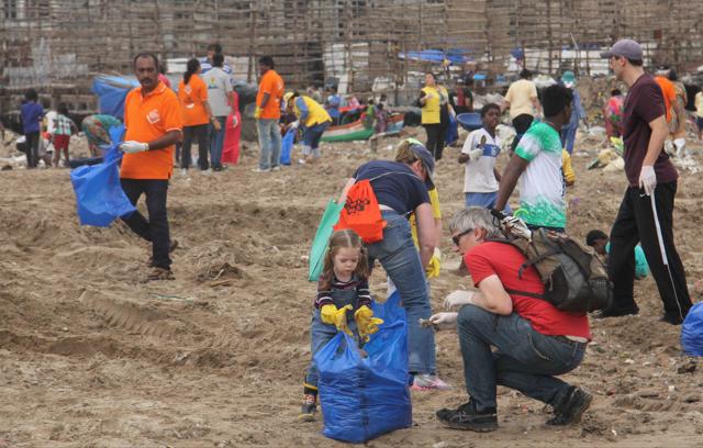 Volunteers take part in the Versova beach clean-up drive on Sunday. (Pramod Thakur/HT)