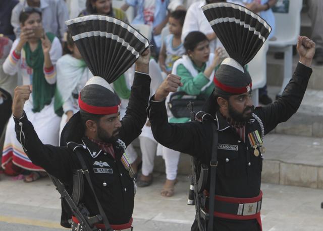 Pakistani border guards gesture while looking at their Indian counterpart during a daily border closing ceremony at sunset, at the Wagah border post. (AP Photo) Pakistani border guards gesture while looking at their Indian counterpart during a daily border closing ceremony at sunset, at the Wagah border post. (AP Photo)