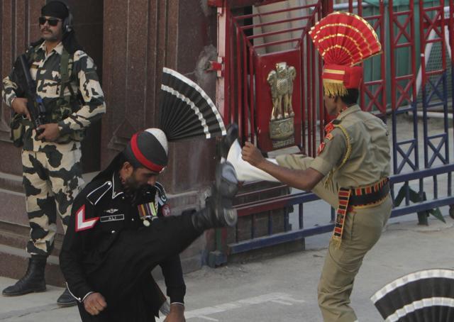 A Pakistani border guard, in black uniform, takes part in a daily border closing ceremony with his Indian counterpart at the Wagah border. (AP Photo) A Pakistani border guard, in black uniform, takes part in a daily border closing ceremony with his Indian counterpart at the Wagah border. (AP Photo)