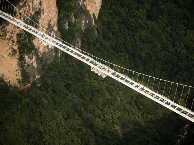 The world's highest and longest glass-bottomed bridge is seen above a valley in Zhangjiajie in China's Hunan Province. (AFP File Photo) The world's highest and longest glass-bottomed bridge is seen above a valley in Zhangjiajie in China's Hunan Province. (AFP File Photo)