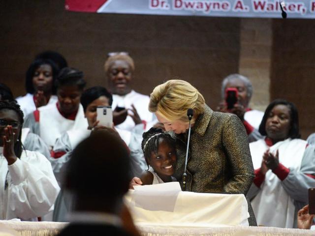 Democratic presidential candidate Hillary Clinton hugs Zianna Oliphant after inviting her to the stage as she finishes speaking at Little Rock AME Zion church in Charlotte. (AP Photo) Democratic presidential candidate Hillary Clinton hugs Zianna Oliphant after inviting her to the stage as she finishes speaking at Little Rock AME Zion church in Charlotte. (AP Photo)