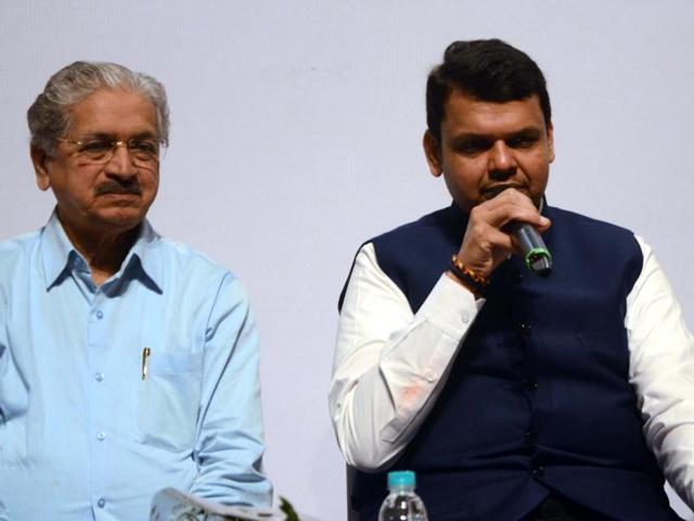 Chief minister Devendra Fadnavis talking to school children from Velha village with industries minister Subhash Desai, education minister Vinod Tawde at Shanmukhananda Hall on Sunday. (Sandeep Mahankal)