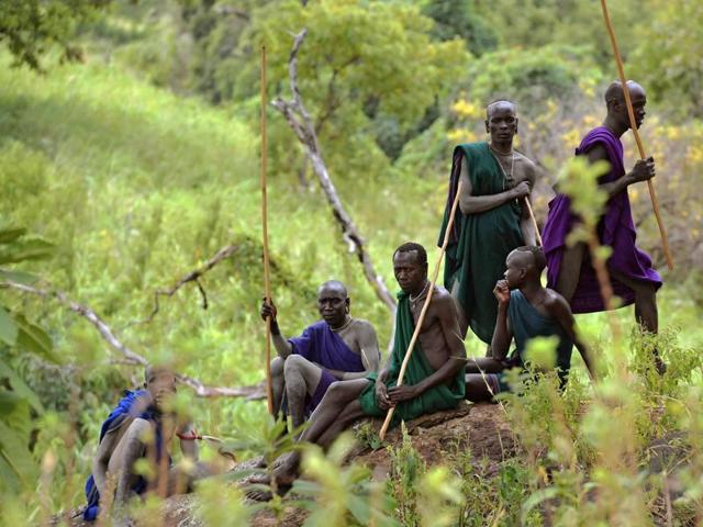 Men from the Suri tribe wait for a Donga or stick fight near Kibbish on September 24, 2016. Traditionally the fight is a way to impress women and find a wife. The fights are brutal and sometimes result in death. The combatants fight with little or no clothing and sometimes no protection at all. (AFP) Men from the Suri tribe wait for a Donga or stick fight near Kibbish on September 24, 2016. Traditionally the fight is a way to impress women and find a wife. The fights are brutal and sometimes result in death. The combatants fight with little or no clothing and sometimes no protection at all. (AFP)