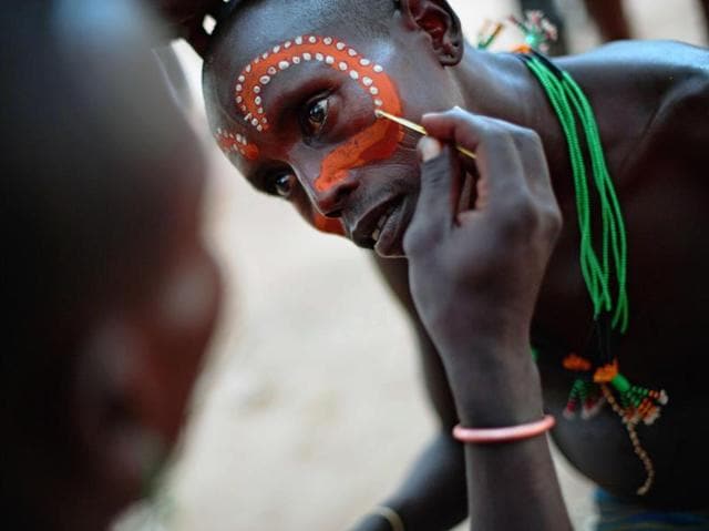 A Hamar man has his face painted before a bull jumping ceremony in Omo Valley region near Turmi on September 19, 2016. The Hamar are a Nilotic ethnic group in Ethiopia. Bull jumping has been practised by the Hamars for thousands of years. The ceremony is a coming of age tradition which allows young men to marry. The man has to run across the backs of bulls which have been lined up, 4 times. If he falls through the row of bulls he is to start again until he finishes without falling. If the man fails to properly “jump the bulls” he risks humiliation and being cast out by his village as well as never being able to marry in the future. Before the ceremony women line up to be whipped by men holding sticks to prove their devotion to the men. (AFP) A Hamar man has his face painted before a bull jumping ceremony in Omo Valley region near Turmi on September 19, 2016. The Hamar are a Nilotic ethnic group in Ethiopia. Bull jumping has been practised by the Hamars for thousands of years. The ceremony is a coming of age tradition which allows young men to marry. The man has to run across the backs of bulls which have been lined up, 4 times. If he falls through the row of bulls he is to start again until he finishes without falling. If the man fails to properly “jump the bulls” he risks humiliation and being cast out by his village as well as never being able to marry in the future. Before the ceremony women line up to be whipped by men holding sticks to prove their devotion to the men. (AFP)