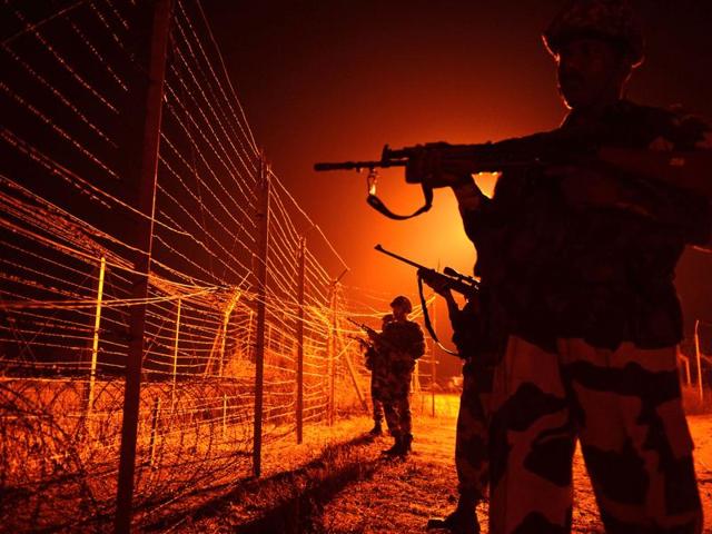 BSF soldiers patrol along a border fence at an outpost along the Line of Control at Abdulian, some 38 kms southwest of Jammu.(AFP File Photo)