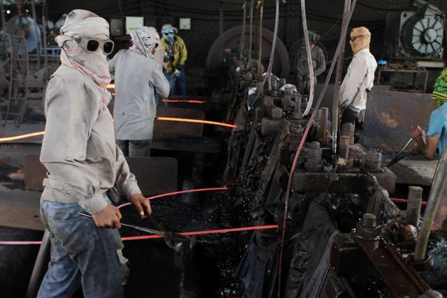 Colleagues of Mubeen Rajhu, who killed his sister Tasleem, work at a steel mill in Lahore. (AP Photo) Colleagues of Mubeen Rajhu, who killed his sister Tasleem, work at a steel mill in Lahore. (AP Photo)