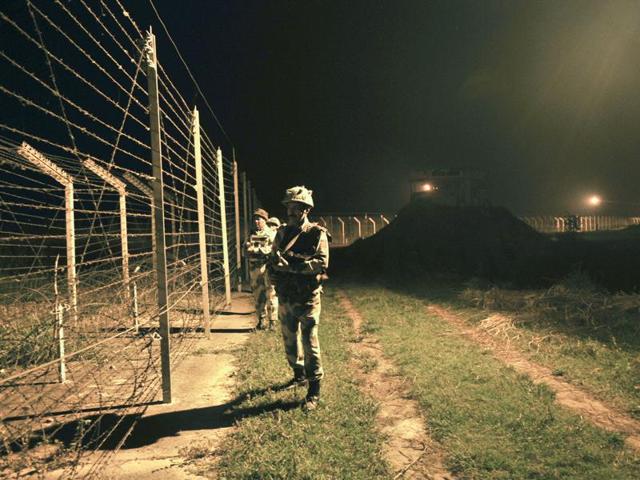 Border Security Force (BSF) soldiers standing guard during a night patrol near the fence at the India-Pakistan International Border at the outpost of Akhnoor sector, about 40 km from Jammu, on Sunday, October 02, 2016.(Nitin Kanotra / HT Photo)