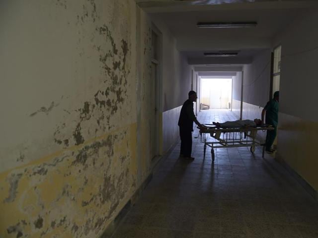 An Afghan patient is wheeled on a trolley past a soaking wall at Salang hospital, north of Kabul. (AFP Photo) An Afghan patient is wheeled on a trolley past a soaking wall at Salang hospital, north of Kabul. (AFP Photo)
