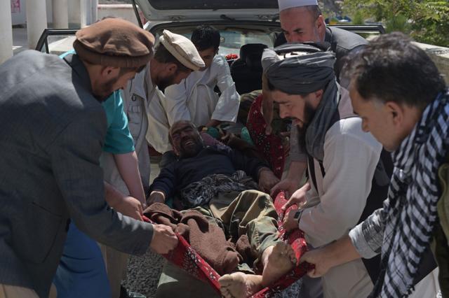 Afghan men carry a man who fell out of a walnut tree towards treatment at a hospital in Salang, north of Kabul. (AFP Photo) Afghan men carry a man who fell out of a walnut tree towards treatment at a hospital in Salang, north of Kabul. (AFP Photo)