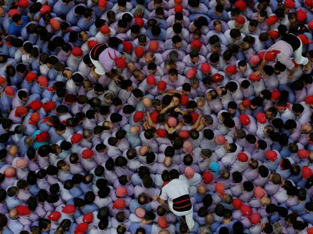 The Spanish people follow a peculiar tradition every year — that of building castells or human towers as long as 10 stories tall. (Reuters)