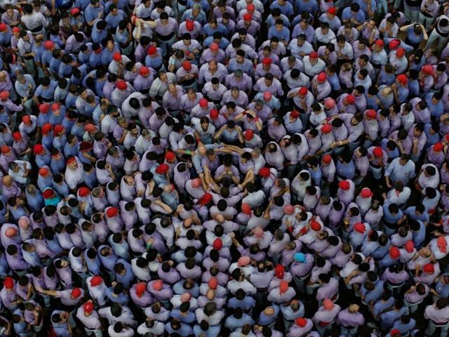 Several teams, colloquially known as colles, engage in a contest to build the tallest and the most complex tower of humans who stand atop of each other. (Reuters)