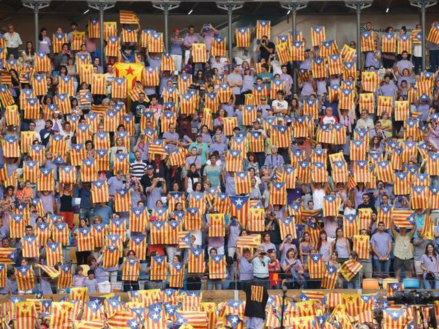 People display esteladas (Catalan separatist flags) during the competition. They do look as excited as the contestants. Don’t they? (Reuters)