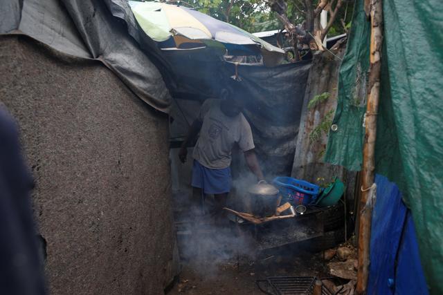 A man cooks a meal for his family at a camp for displaced people while Hurricane Matthew approaches Port-au-Prince, Haiti. (REUTERS) A man cooks a meal for his family at a camp for displaced people while Hurricane Matthew approaches Port-au-Prince, Haiti. (REUTERS)