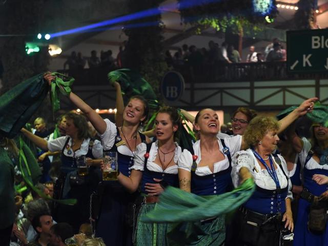 Waitresses celebrate the end of the 183th Oktoberfest on a table in a festival tent of the beer festival in Munich, southern Germany. (AFP) 