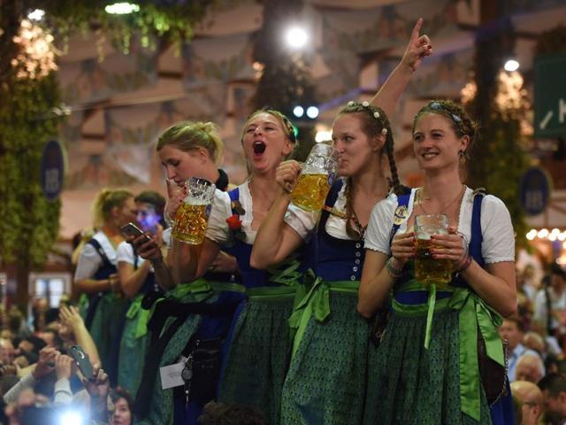 Waitresses celebrate the end of the 183th Oktoberfest on a table in a festival tent of the beer festival in Munich. (AFP) 