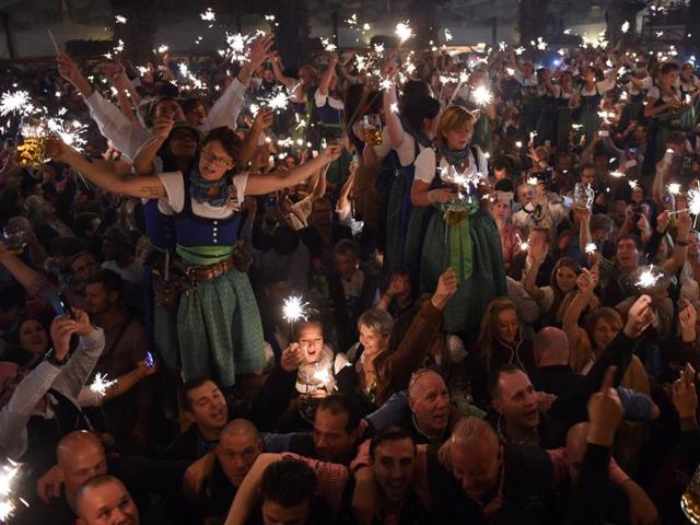 Waitresses celebrate the end of the 183th Oktoberfest on a table in a festival tent of the beer festival in Munich. (AFP) 
