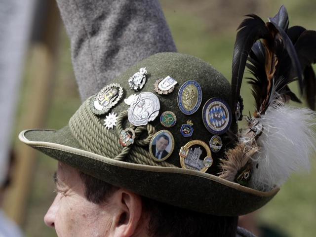 A Bavarian man wearing a hat as rifleman fire their muzzle loaders in front of the Bavaria statue on the last day at the 183rd Oktoberfest beer festival in Munich. (AP) 