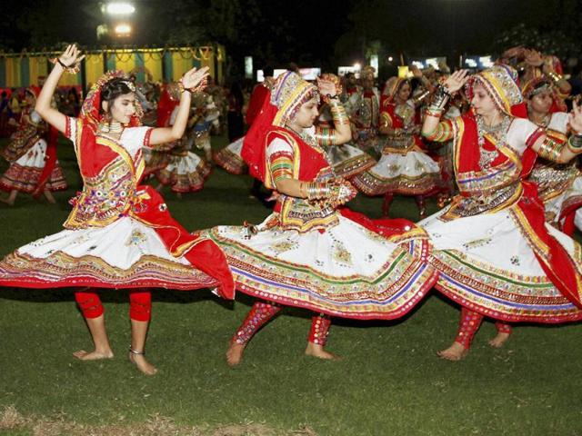Participants dressed in traditional attire perform Garba on the first day of Navratri festival in Ahmedabad on Saturday night. (PTI) Participants dressed in traditional attire perform Garba on the first day of Navratri festival in Ahmedabad on Saturday night. (PTI)