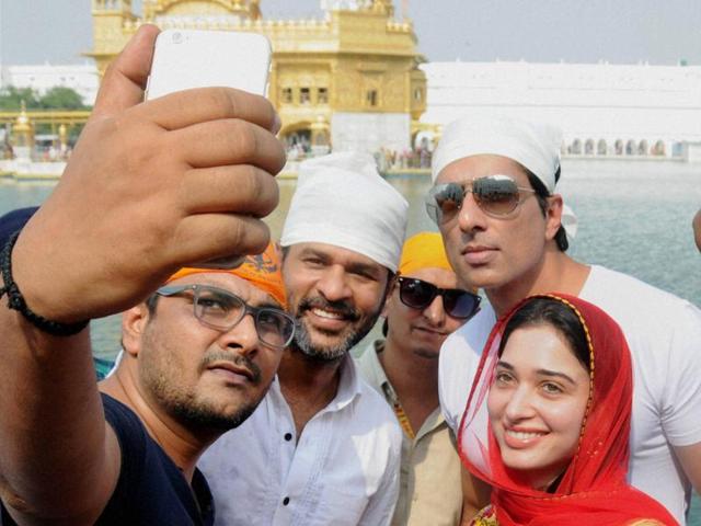 A fan clicks a selfie with Bollywood actors Sonu Sood, Tamannaah and Prabhu Deva during the promotion of their upcoming movie Tutak Tutak Tutiya at Golden Temple in Amritsar. (PTI Photo)