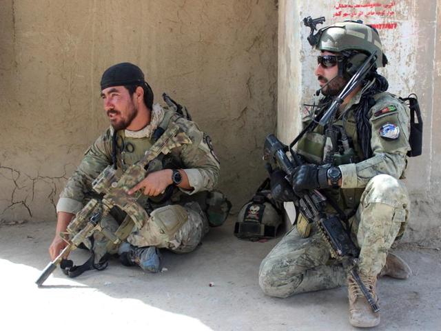 Afghan National Army commandos sit on their armoured vehicles amid ongoing fighting between Taliban militants and Afghan security forces in Kunduz on October 4, 2016.(AFP) Afghan National Army commandos sit on their armoured vehicles amid ongoing fighting between Taliban militants and Afghan security forces in Kunduz on October 4, 2016.(AFP)