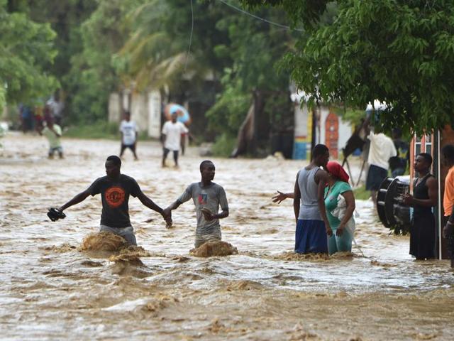 People try to cross the overflowing Rouyonne river in the commune of Leogane, south of Port-au-Prince. (AFP Photo) People try to cross the overflowing Rouyonne river in the commune of Leogane, south of Port-au-Prince. (AFP Photo)