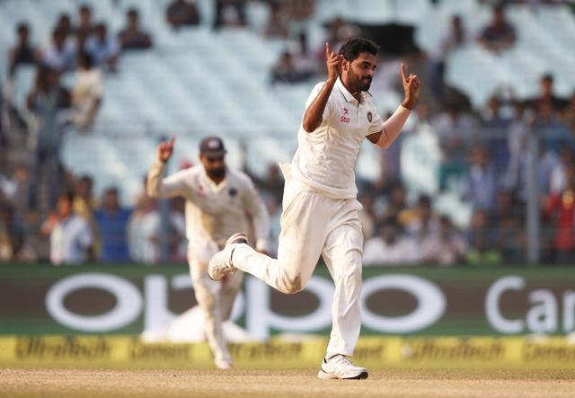 Indian bowler Bhuvneshwar Kumar celebrates after taking the wicket of New Zealand's Jeetan Patel. (AP Photo)